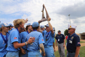 St. Michael Mikes players celebrate with the state title trophy for Div. I.