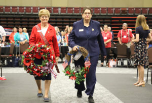 Outgoing President Mary Kuperus and Outgoing Commander Jennifer Havlick carry wreaths during the Memorial Service on July 13.