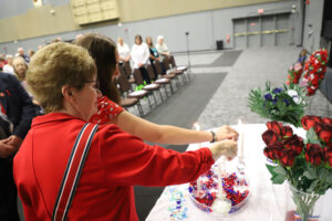 Outgoing President Mary Kuperus and Outgoing Honorary Junior President Sydney Borntrager light a candle at the Memorial Service at the Department Convention on July 13.