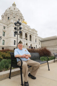 Bill Strusinski of Forest Lake Post 225 sits on a bench in front of the State Capitol on May 8. He works as a lobbyist for Libby Law Office in St. Paul and served his country with the 1st Infantry Division.