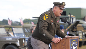 A general speaks into a microphone.
