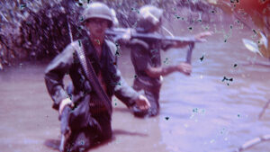 Soldiers wading through a swamp in Vietnam