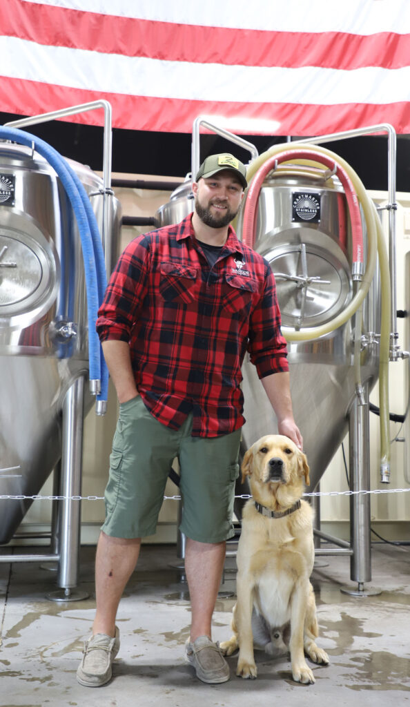 Matt Caple stands with his loyal dog, Deacon, at Warrior Brewing in Duluth.