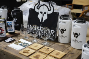 The brewery area features a display of some Warrior Brewing Co. products.