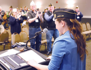 Legion members applaud young female for joining military and joining the Legion. 
